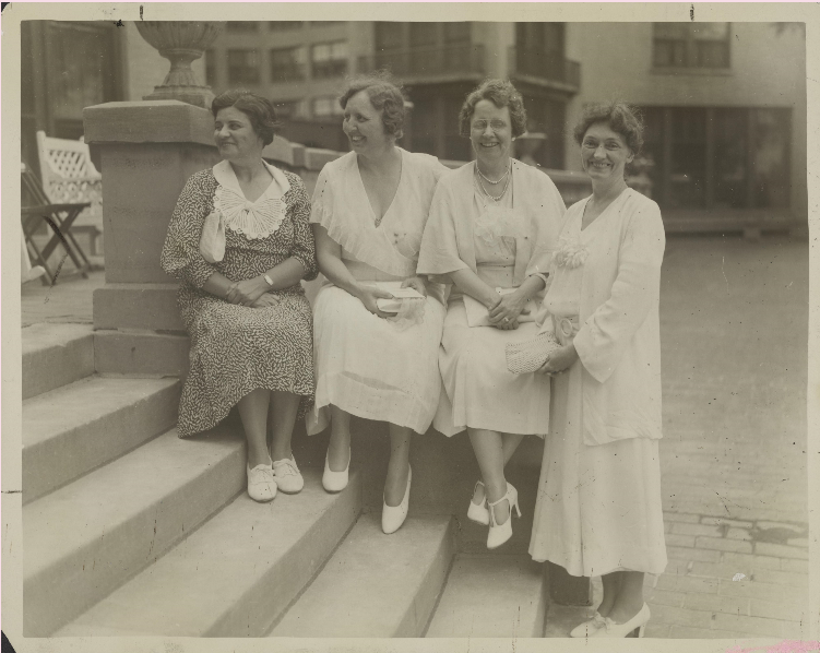 historical photo of Phi Mu sisters sitting on campus steps