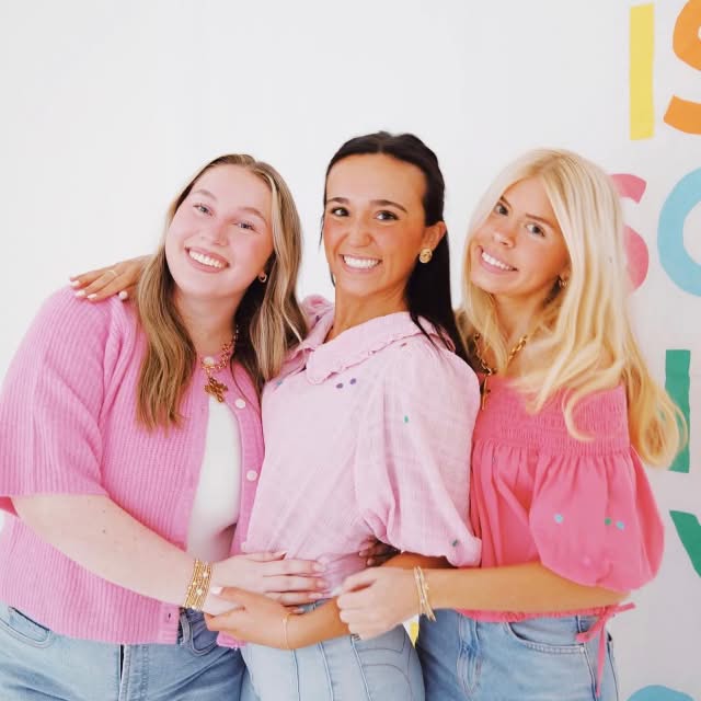 3 sisters hugging smiling at the camera