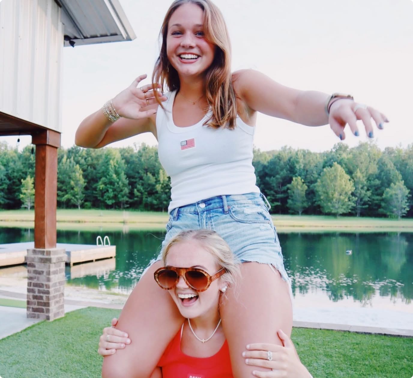 sister sitting on another sisters shoulders