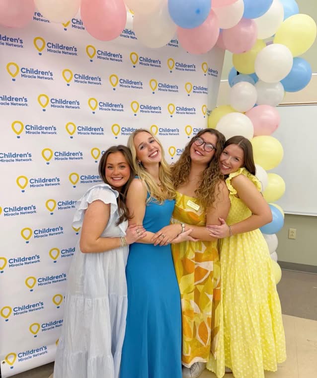 PMU-sisters-cheering-outside-charity-building-childrens-miracle-network-small@2x
