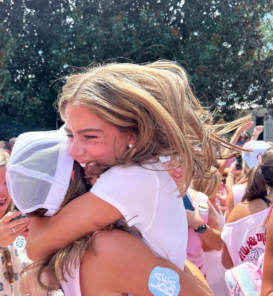 Girl hugging another girl energetically happy